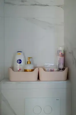 a shelf with soap and other bathroom items on it at LALA & DAUGHTERS Apartment in Vrnjačka Banja