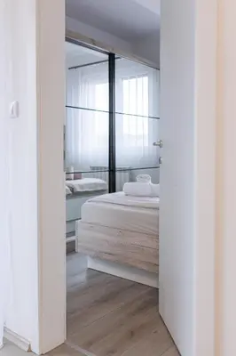 a bedroom with a bed and a mirror at Pirot LUX 1 in Pirot