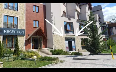 a building with a sign on the side of it at N-LUX 66 MILMARI kopaonik in Kopaonik