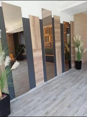 a row of mirrors on a wall in a room at N-LUX 66 MILMARI kopaonik in Kopaonik