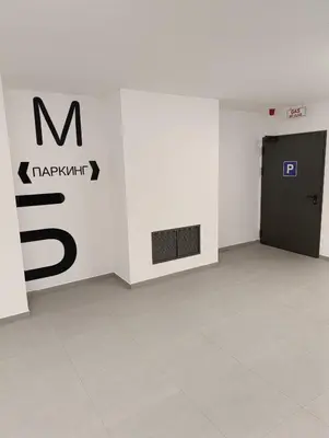 a room with a black door and a wall at Planet Green Residence in Niš