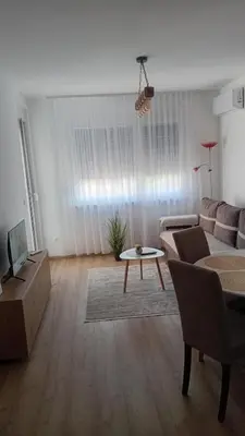 a living room with a couch and a table at Apartman Rajska Vila in Vrnjačka Banja