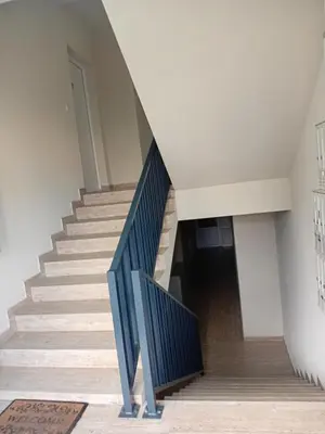 a staircase with blue railings in a building at Apartman Rajska Vila in Vrnjačka Banja