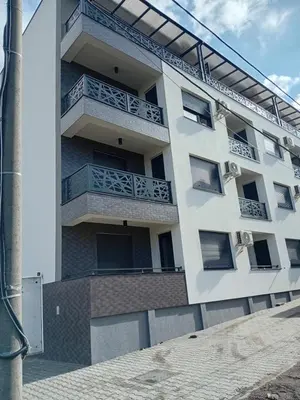 an apartment building with balconies on the side of it at Apartman Rajska Vila in Vrnjačka Banja