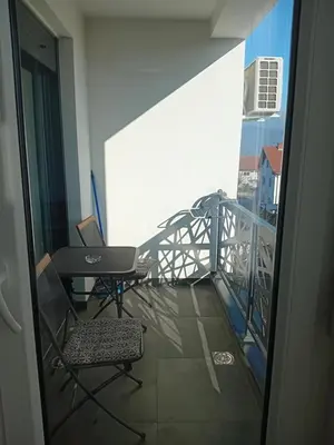 a balcony with a desk and a laptop on it at Apartman Rajska Vila in Vrnjačka Banja