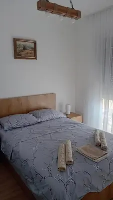 a bedroom with a bed with two pillows on it at Apartman Rajska Vila in Vrnjačka Banja