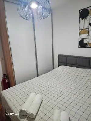 a bedroom with a bed with towels on it at Blue Wave Vrnjacka banja in Vrnjačka Banja