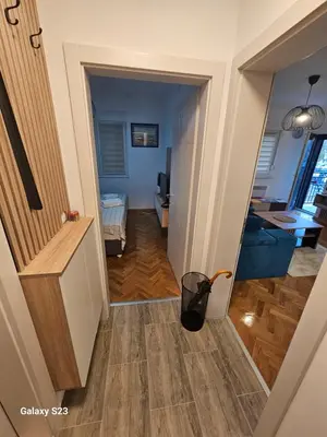 a hallway leading into a living room with a trash can at Blue Wave Vrnjacka banja in Vrnjačka Banja