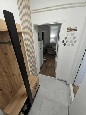 a hallway leading to a living room with a door at BK Apartment in Niš