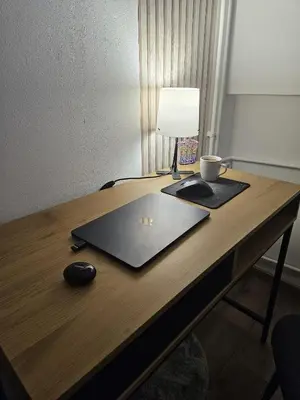 a desk with a laptop and a lamp on it at BK Apartment in Niš