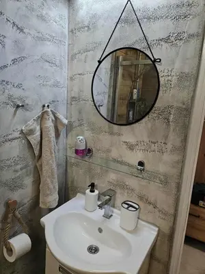 a bathroom with a sink and a mirror at BK Apartment in Niš