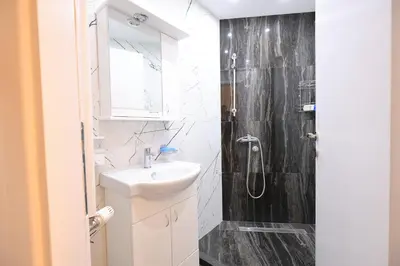 a bathroom with a sink and a shower at Vila Nikola Nature and Mind Retreat House