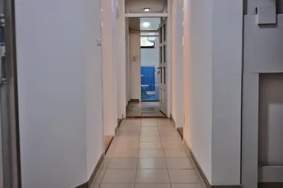 a hallway with white walls and a tile floor at Vila Nikola Nature and Mind Retreat House