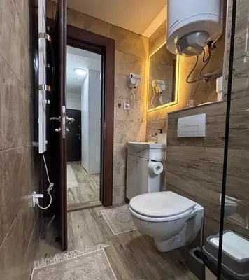 a bathroom with a toilet and a sink at Monte LUX 10 in Kopaonik