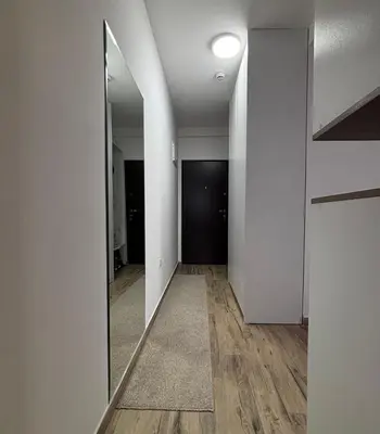 an empty hallway with a mirror on the wall at Monte LUX 10 in Kopaonik