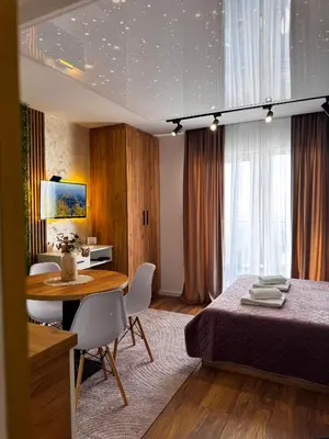 a bedroom with a bed and a table and chairs at Apartman STARS in Kopaonik