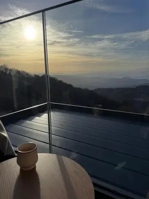 a room with a table and a view of the mountains at Apartman STARS in Kopaonik