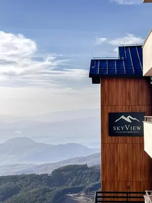 a building with a sign on the side of it at Apartman STARS in Kopaonik