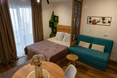 a hotel room with a bed and a couch at Apartman STARS in Kopaonik
