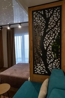 a bedroom with a tree mural on the wall at Apartman STARS in Kopaonik