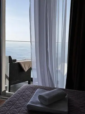 a bedroom with a bed with a view of the ocean at Apartman STARS in Kopaonik