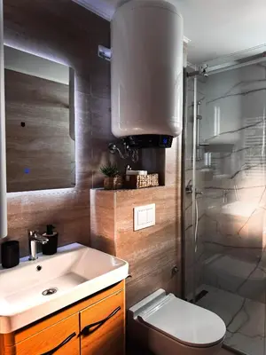a bathroom with a sink and a toilet and a shower at Apartman STARS in Kopaonik