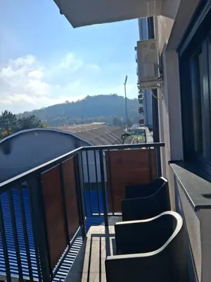 a balcony with chairs and a view of a building at Centar Crnjanski 2 in Jagodina