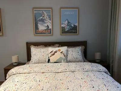a bedroom with a bed and two pictures on the wall at Apartman Nikolic 418 in Kopaonik