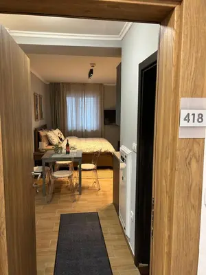 a room with a bed and a table and a dining room at Apartman Nikolic 418 in Kopaonik