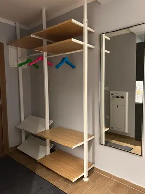a room with wooden shelves and a mirror at Apartman Nikolic 418 in Kopaonik