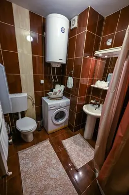 a small bathroom with a toilet and a sink at Apartman Lusi Vranje in Vranje