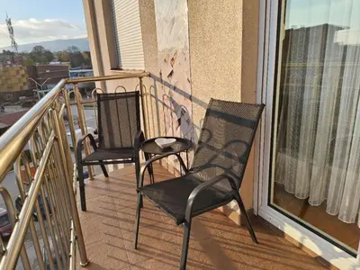 two chairs sitting on the balcony of a condo at Apartman Lusi Vranje in Vranje