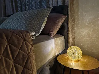a bed with a side table next to a side tablengthngthngth at Apartman Lusi Vranje in Vranje