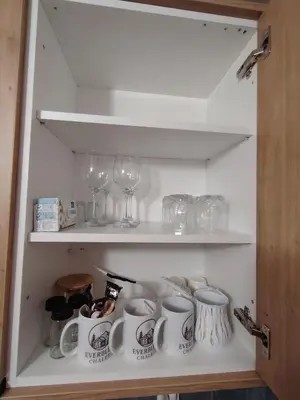 a cupboard with wine glasses and wine glasses at Everblue Chalet Kopaonik in Kopaonik