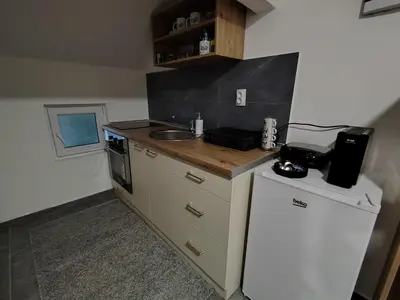 a small kitchen with a sink and a refrigerator at Everblue Chalet Kopaonik in Kopaonik