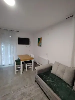 a living room with a couch and a table at Everblue Chalet Kopaonik in Kopaonik