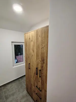 a wooden cabinet in a room with a window at Everblue Chalet Kopaonik in Kopaonik