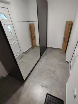 a room with two mirrors and a tile floor at Everblue Chalet Kopaonik in Kopaonik