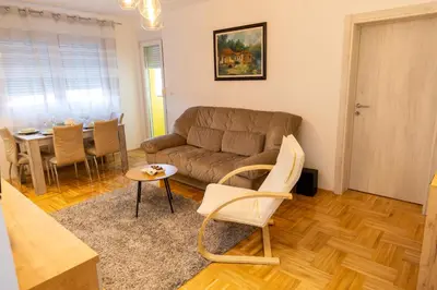 a living room with a couch and a table at APARTMAN ANASTASIJA i DANKA in Pirot