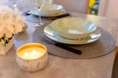 a table with plates and a candle on a table at APARTMAN ANASTASIJA i DANKA in Pirot