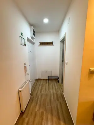 an empty hallway with a bench in a room at APARTMAN ANASTASIJA i DANKA in Pirot