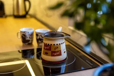 two coffee cups sitting on a tray on a table at APARTMAN ANASTASIJA i DANKA in Pirot