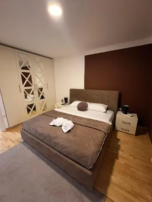 a bedroom with a bed with two towels on it at NAR Royalton Apartment #27 Free Parking in Niš