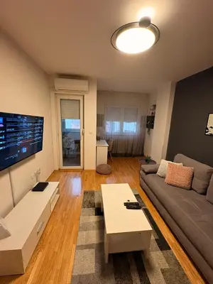 a living room with a couch and a tv at NAR Royalton Apartment #27 Free Parking in Niš