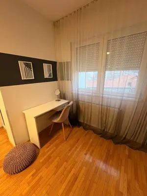 a room with a desk and a chair and a window at NAR Royalton Apartment #27 Free Parking in Niš