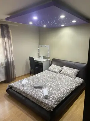 a bedroom with a bed and a desk with a computer at Panorama Bulevar in Niš