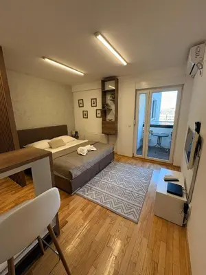 a bedroom with a bed and a large window at NAR Royalton Suite #65 Free Parking in Niš