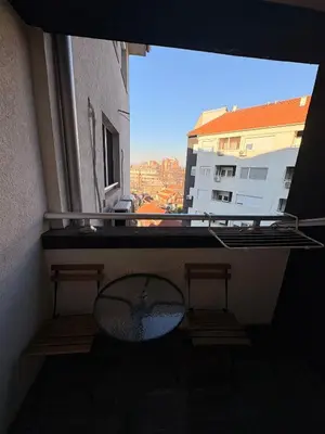 a balcony with a table and a view of a building at NAR Royalton Suite #65 Free Parking in Niš