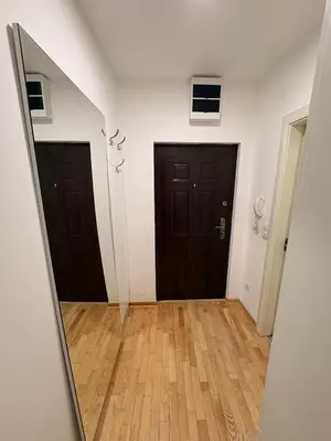 an empty room with two doors and a mirror at NAR Royalton Suite #65 Free Parking in Niš