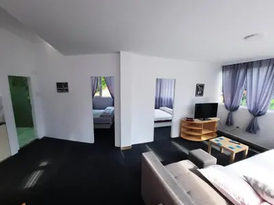 a living room with a couch and a tv at Panorama Borsko jezero in Beljevina